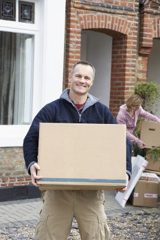 Man and van service loading items into a vehicle