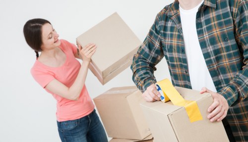 Professional movers loading furniture into a removal truck in Camdentown