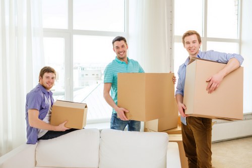 Professional moving team loading boxes into a removal van